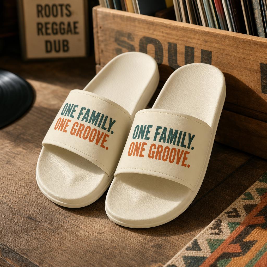 Cream slide sandals printed with One Family. One Groove.